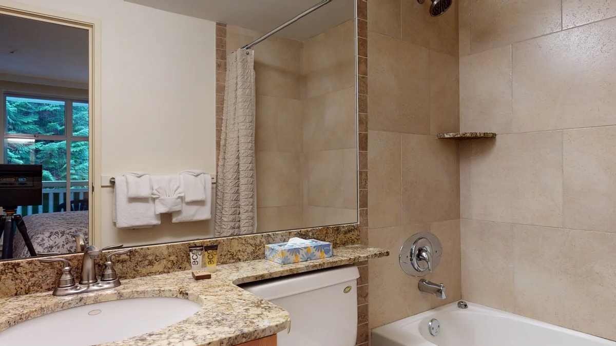 Ensuite washroom with shower-tub combo