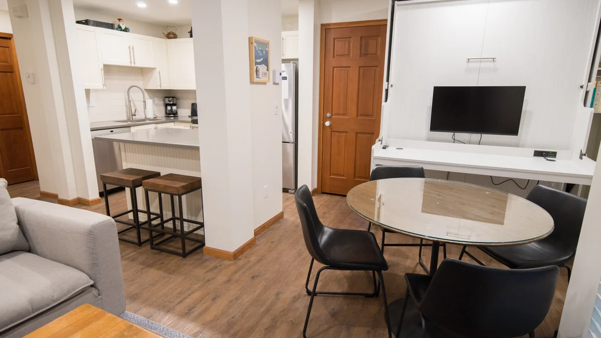 Dining area for four with a fold down double murphy bed in the back